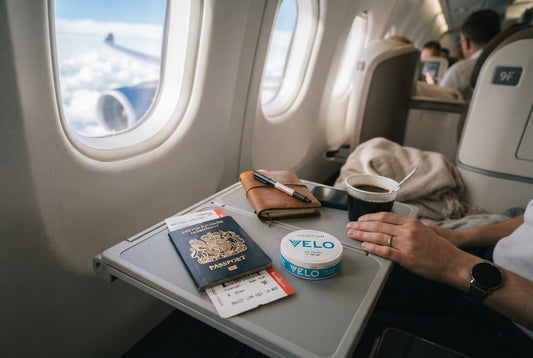 Can you take snus on a plane? Travel essentials with passport, boarding pass, and a nicotine pouch can on a tray table — UK travel guide